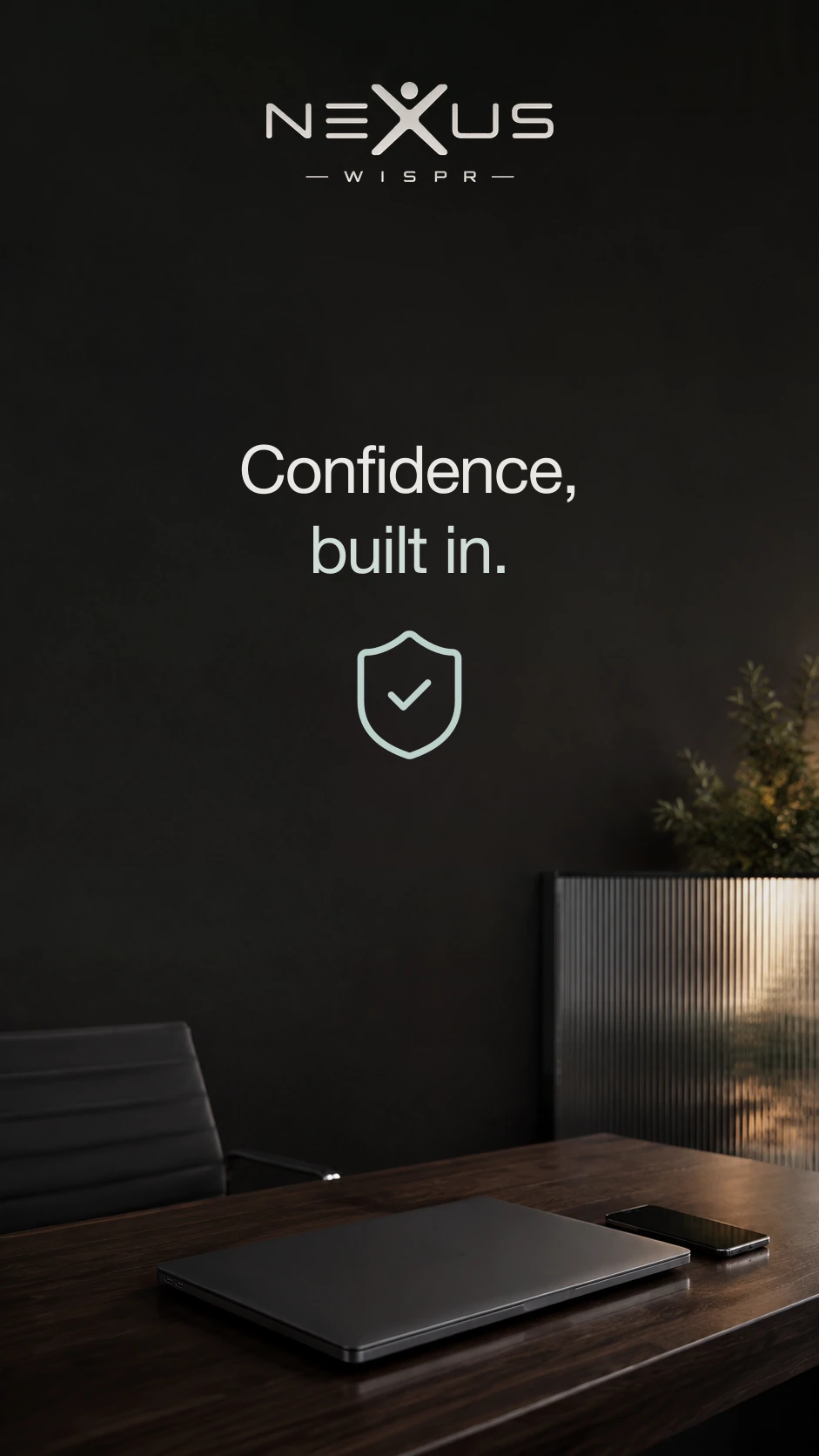 Nexus Wispr logo and the two-line slogan “Confidence, built in.” above a shield with a checkmark, with a closed laptop and phone on the desk.